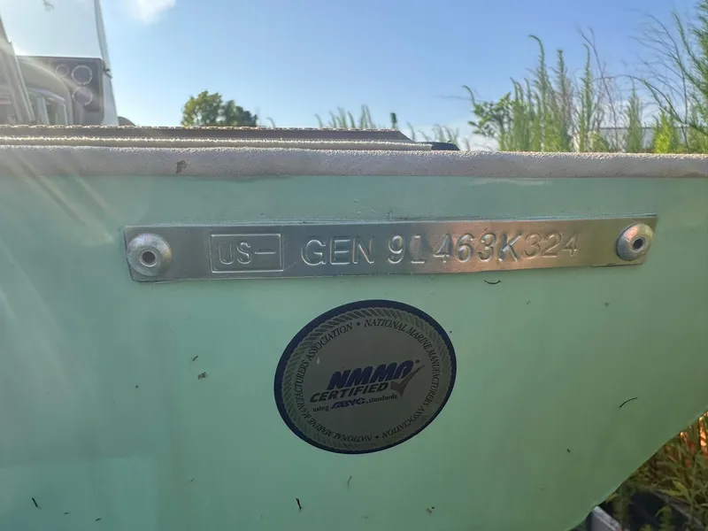 Slide: The Image of 2024 G3 Bay 20 GX boat with hull identification number and NMMA certification sticker. - 18