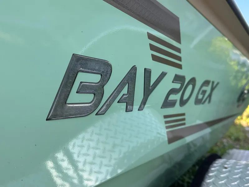 Slide: The Image of 2024 G3 Bay 20 GX boat logo on light green surface. - 2