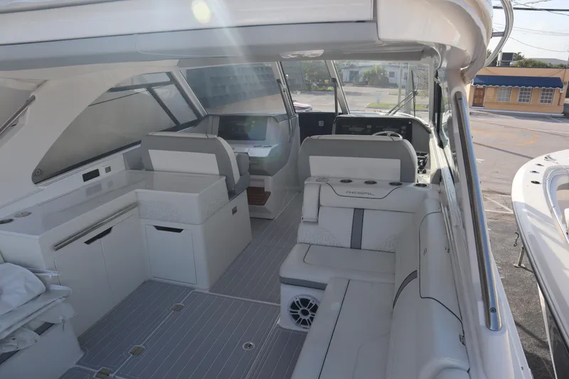 Slide: The Image of 2022 Regal LX36 boat interior with modern seating and helm, showcasing luxury design. - 21