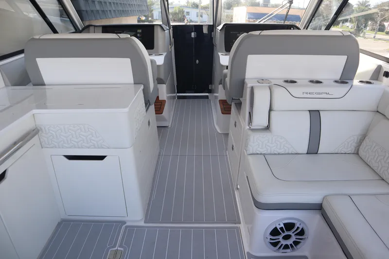 Slide: The Image of Interior of a 2022 Regal LX36 boat, featuring sleek seating and modern design elements. - 22