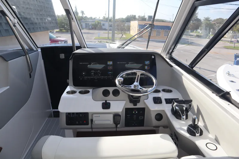 Slide: The Image of 2022 Regal LX36 boat cockpit with modern steering and control panel. - 23
