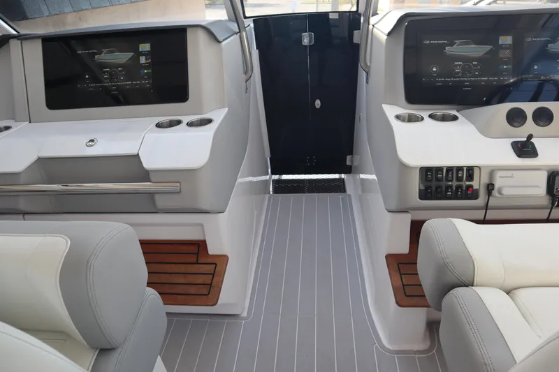Slide: The Image of 2022 Regal LX36 boat interior with modern dashboard and seating. - 26