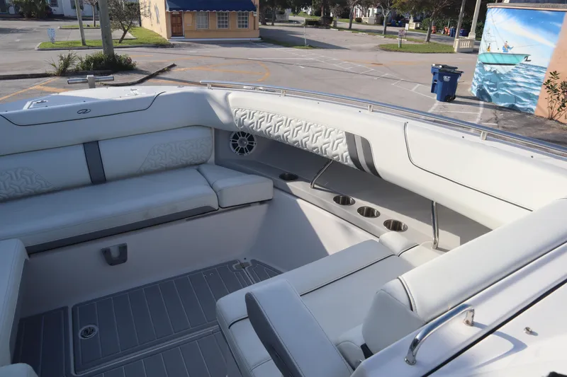 Slide: The Image of Luxurious interior of a 2022 Regal LX36 boat with plush seating and cup holders. - 28