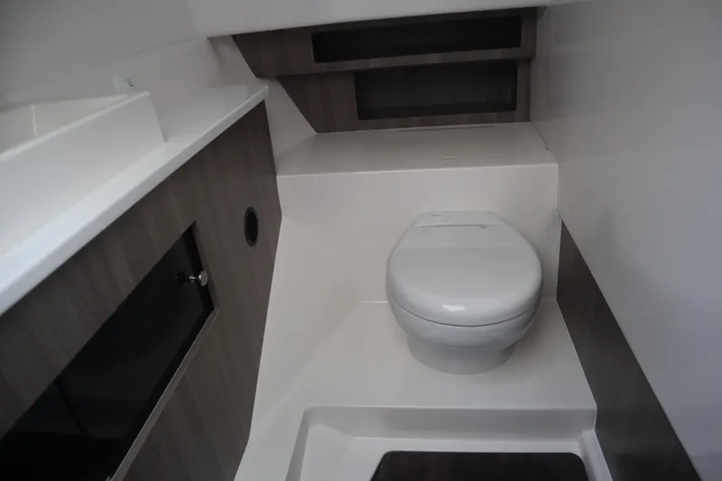 Slide: The Image of 2022 Regal LX36 boat bathroom with modern design and compact toilet. - 37