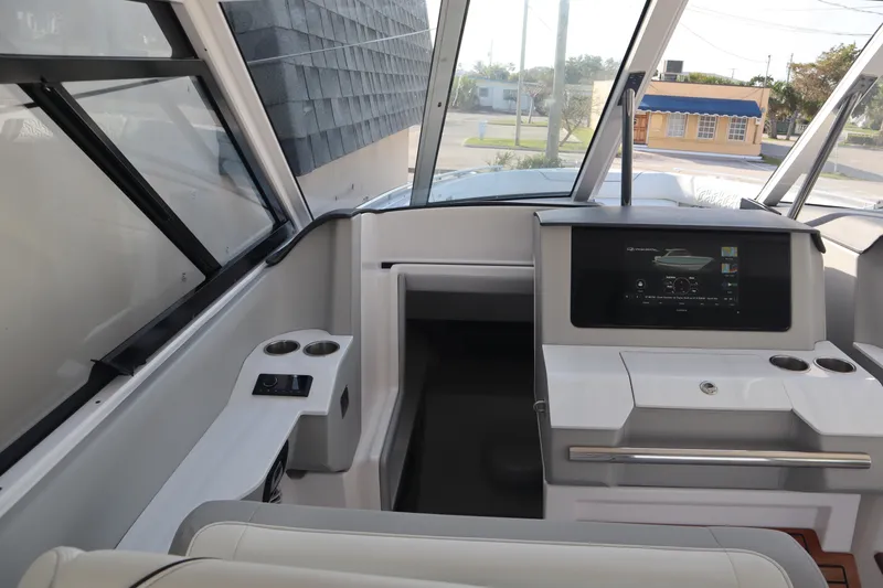 Slide: The Image of Interior of a 2022 Regal LX36 boat, featuring a modern helm and navigation system. - 39