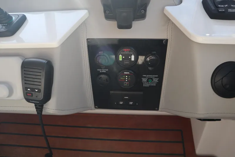 Slide: The Image of Control panel of a 2022 Regal LX36 boat with microphone and switches. - 41