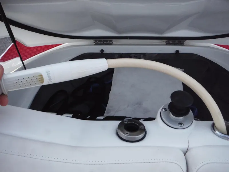 Slide: The Image of 2012 Sea-Doo Sport Boats 200 Speedster engine compartment with hose attachment. - 17