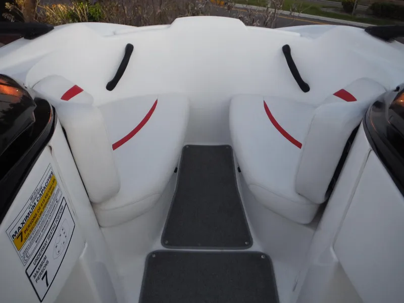 Slide: The Image of 2012 Sea-Doo Sport Boats 200 Speedster interior seating with red accents and capacity label. - 21