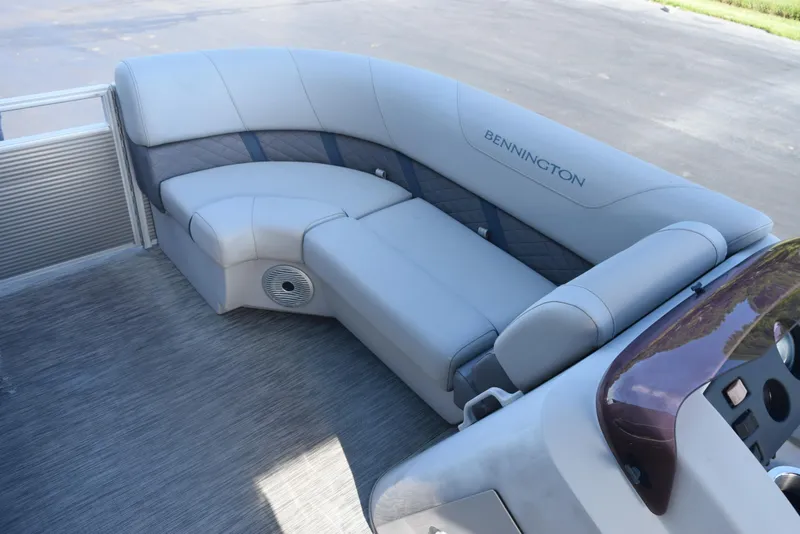 Slide: The Image of 2021 Bennington 18 SLX pontoon boat interior with gray seating and console. - 13