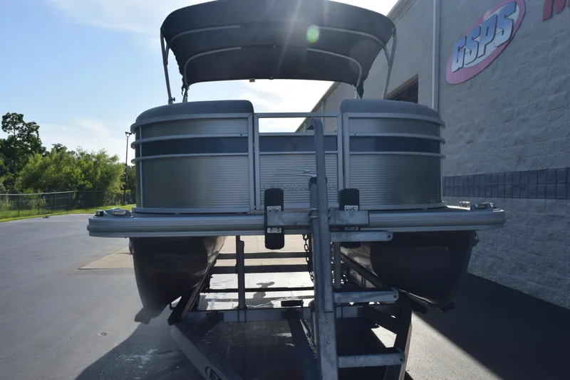 Slide: The Image of 2021 Bennington 18 SLX pontoon boat on trailer, parked outside dealership. - 3
