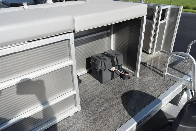 Slide: The Image of 2021 Bennington 18 SLX pontoon boat interior with storage compartments and battery setup. - 7