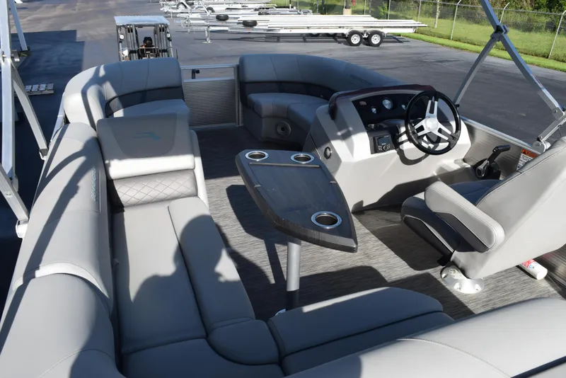 Slide: The Image of 2021 Bennington 18 SLX pontoon boat interior with gray seating and steering console. - 8