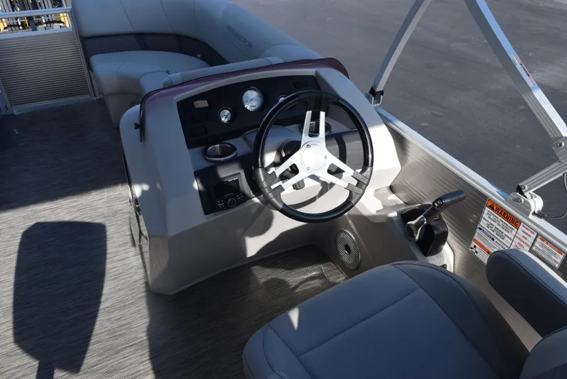 Slide: The Image of 2021 Bennington 18 SLX boat interior with steering wheel and seating area. - 9
