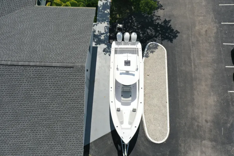 Slide: The Image of Aerial view of 2026 Jupiter 340LS boat parked beside a building. - 1