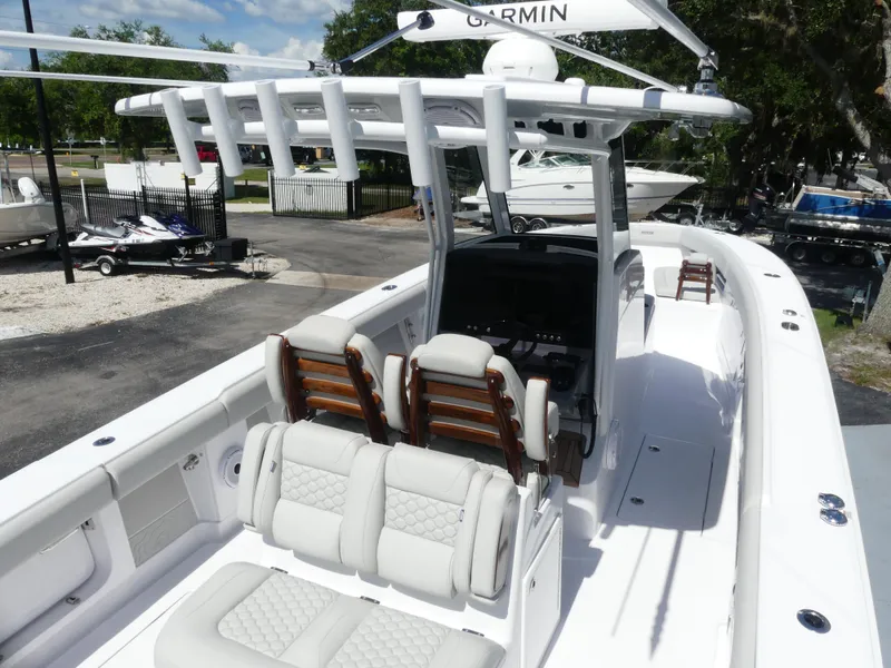 Slide: The Image of 2026 Jupiter 340LS boat interior with white seating and advanced navigation equipment. - 11