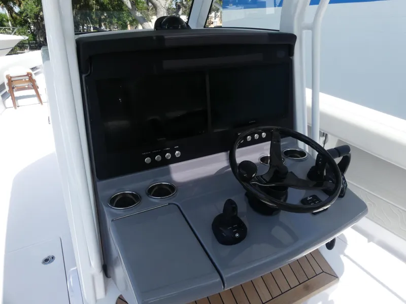 Slide: The Image of Helm of 2026 Jupiter 340LS boat with steering wheel and control panel. - 14