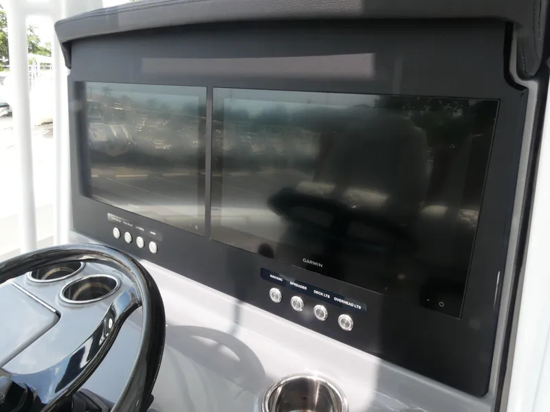 Slide: The Image of Dual Garmin displays on 2026 Jupiter 340LS boat dashboard with steering wheel. - 17