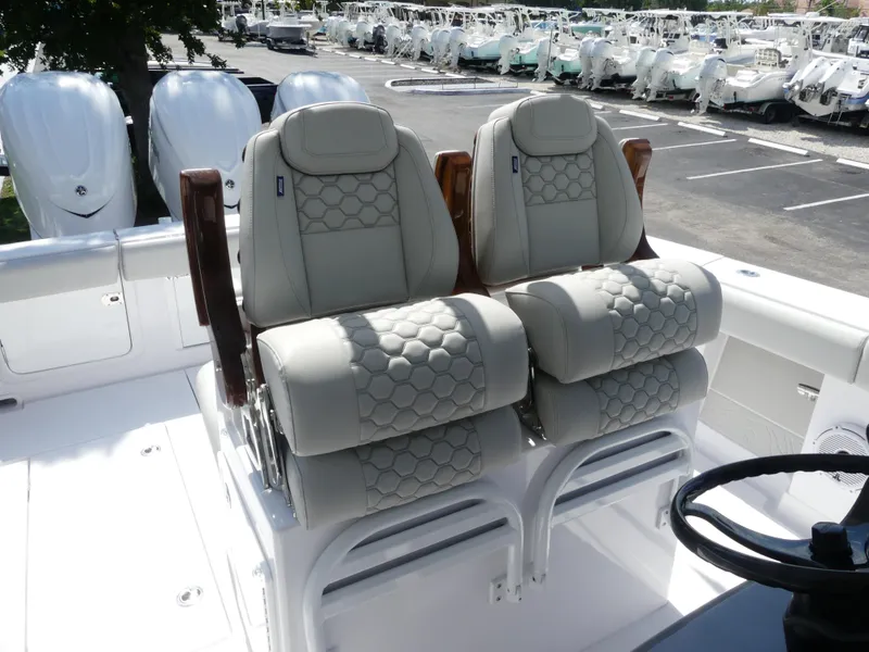 Slide: The Image of Luxury seating on 2026 Jupiter 340LS boat, featuring plush, hexagonal-patterned upholstery. - 18