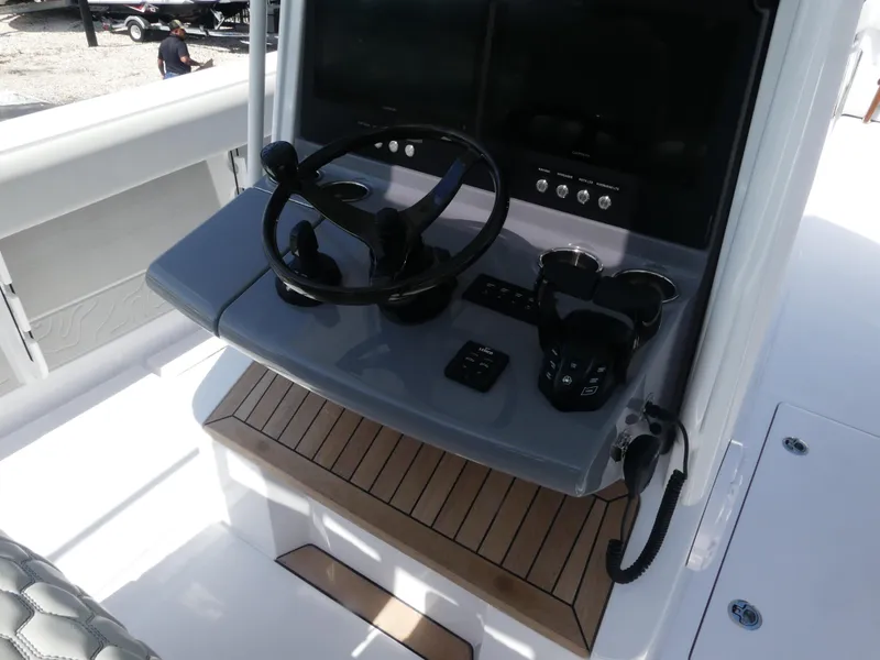Slide: The Image of Helm of 2026 Jupiter 340LS boat with steering wheel and controls. - 19