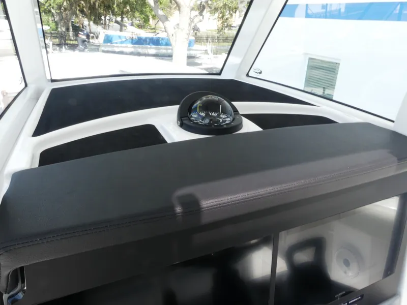 Slide: The Image of Interior view of 2026 Jupiter 340LS boat dashboard with compass and navigation equipment. - 21