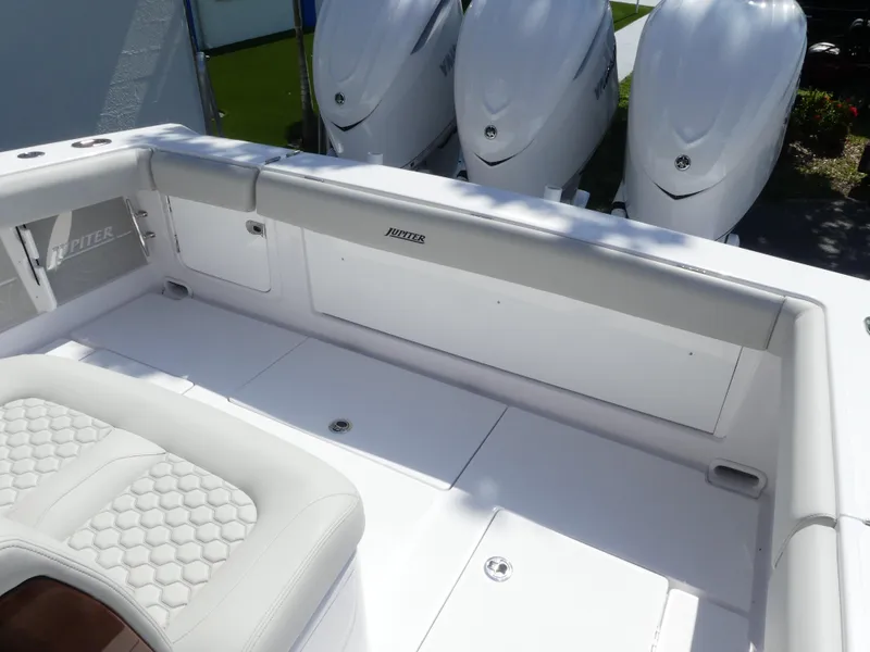 Slide: The Image of 2026 Jupiter 340LS boat interior with triple outboard engines, featuring white seating and deck. - 22