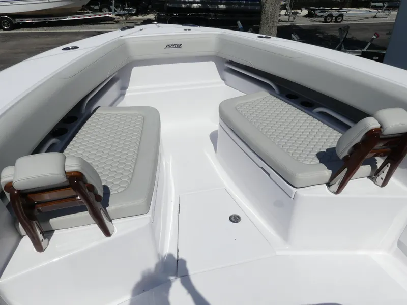 Slide: The Image of 2026 Jupiter 340LS boat interior with cushioned seating and sleek design. - 25