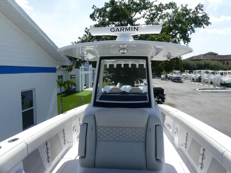 Slide: The Image of 2026 Jupiter 340LS boat with Garmin equipment, docked near a marina. - 27