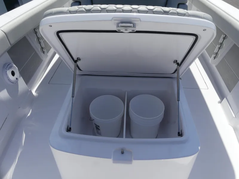 Slide: The Image of Open storage compartment on 2026 Jupiter 340LS boat with two white buckets inside. - 28