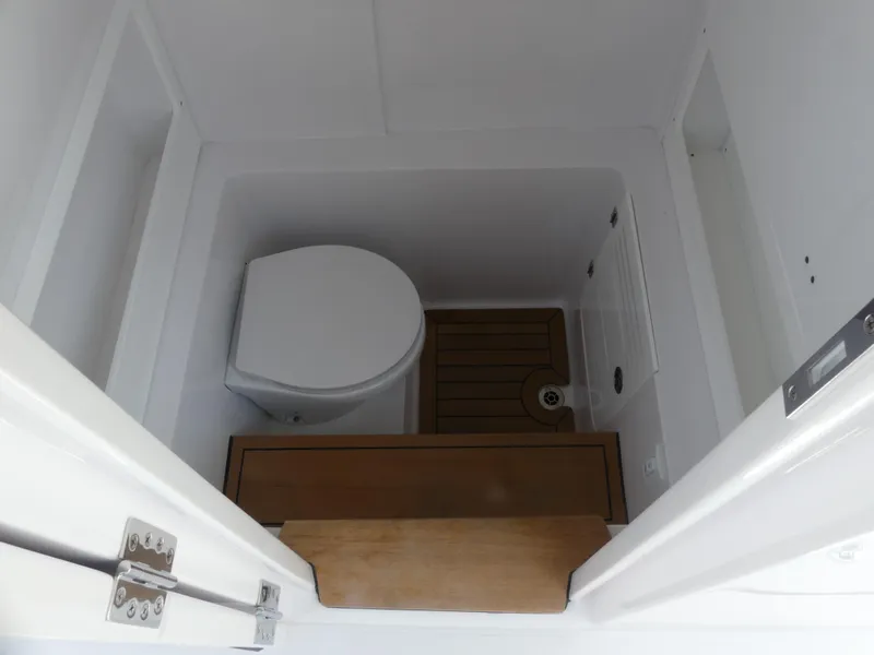 Slide: The Image of Compact marine bathroom in 2026 Jupiter 340LS boat, featuring a toilet and wooden flooring. - 30