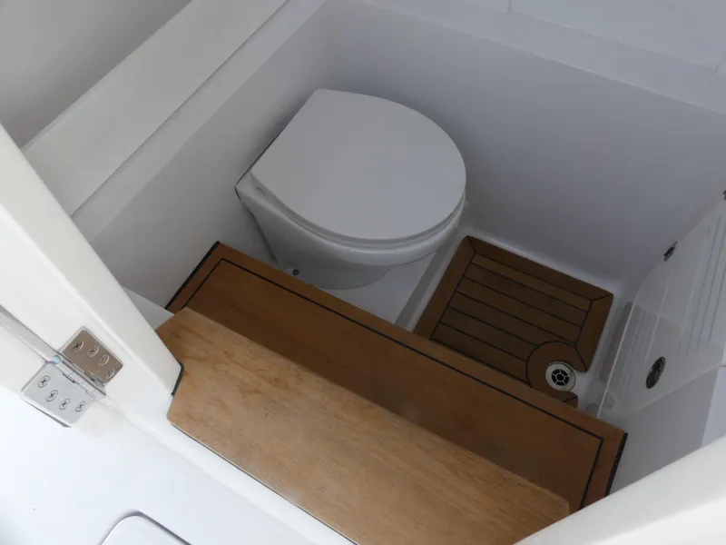 Slide: The Image of Compact marine bathroom in 2026 Jupiter 340LS boat with wooden flooring and modern toilet. - 31