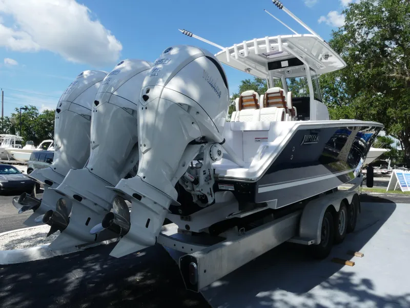 Slide: The Image of 2026 Jupiter 340LS boat with triple outboard engines on a trailer. - 8