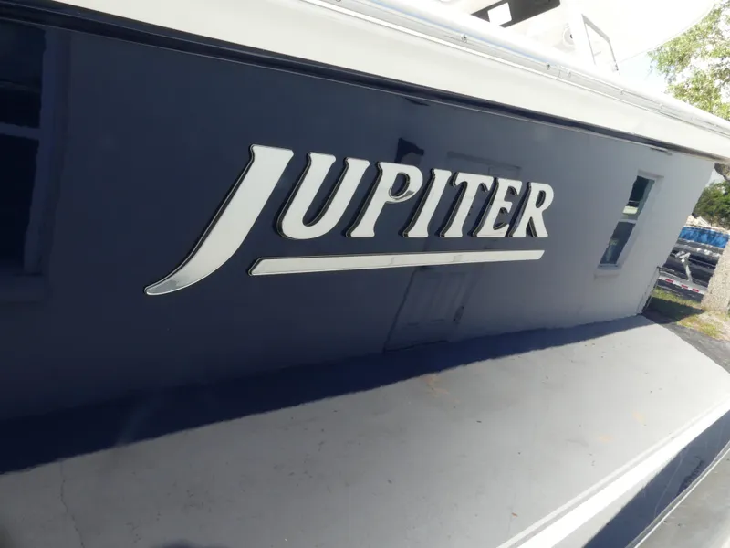 Slide: The Image of 2026 Jupiter 340LS boat with bold logo on dark hull. - 9