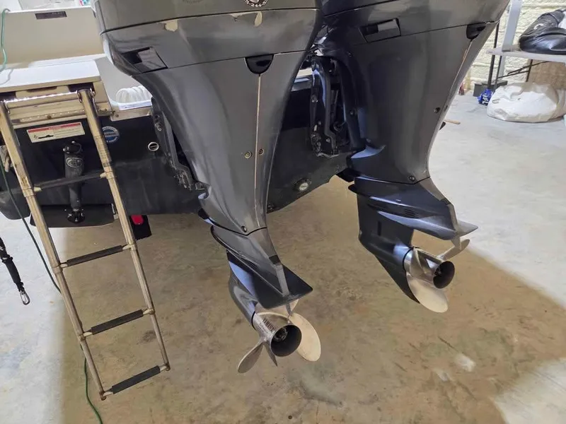 Slide: The Image of Twin outboard motors on a 2013 Sailfish 290 CC boat with a ladder. - 12