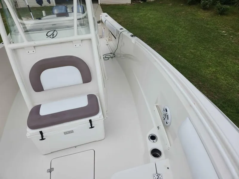 Slide: The Image of 2013 Sailfish 290 CC boat interior with seating and storage compartments. - 17