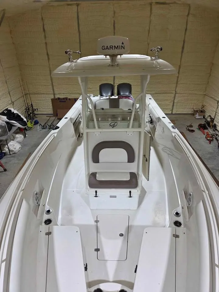 Slide: The Image of 2013 Sailfish 290 CC boat interior with Garmin equipment in a storage facility. - 6