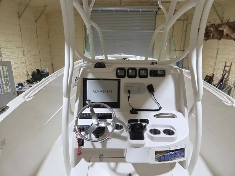 Slide: The Image of 2013 Sailfish 290 CC boat console with Garmin navigation system in a garage. - 8