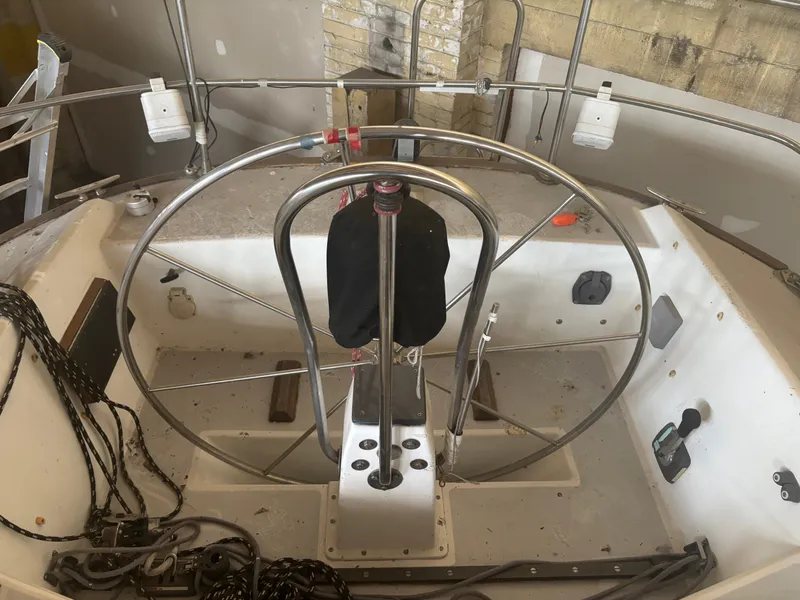 Slide: The Image of Cockpit of a 1987 Holby Tripp sailboat with steering wheel and control panel. - 18