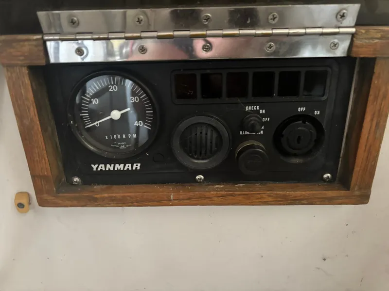 Slide: The Image of 1987 Holby Tripp engine control panel with Yanmar tachometer and switches. - 23