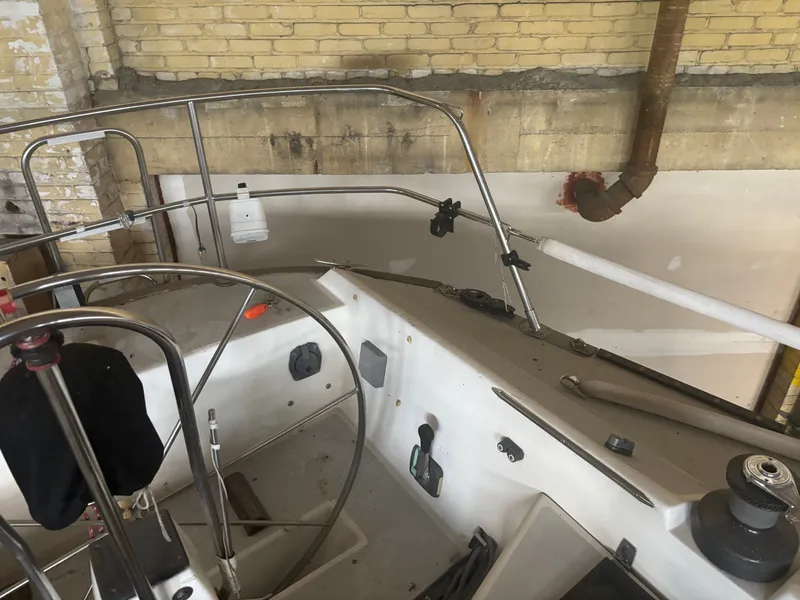 Slide: The Image of Interior of a 1987 Holby Tripp boat with steering wheel and controls. - 24