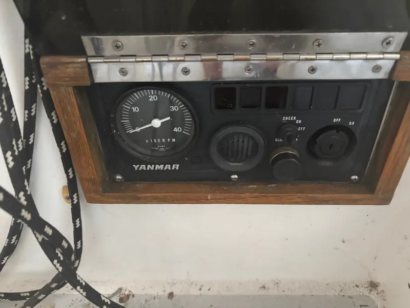 Slide: The Image of Control panel of a 1987 Holby Tripp boat featuring a Yanmar tachometer. - 26