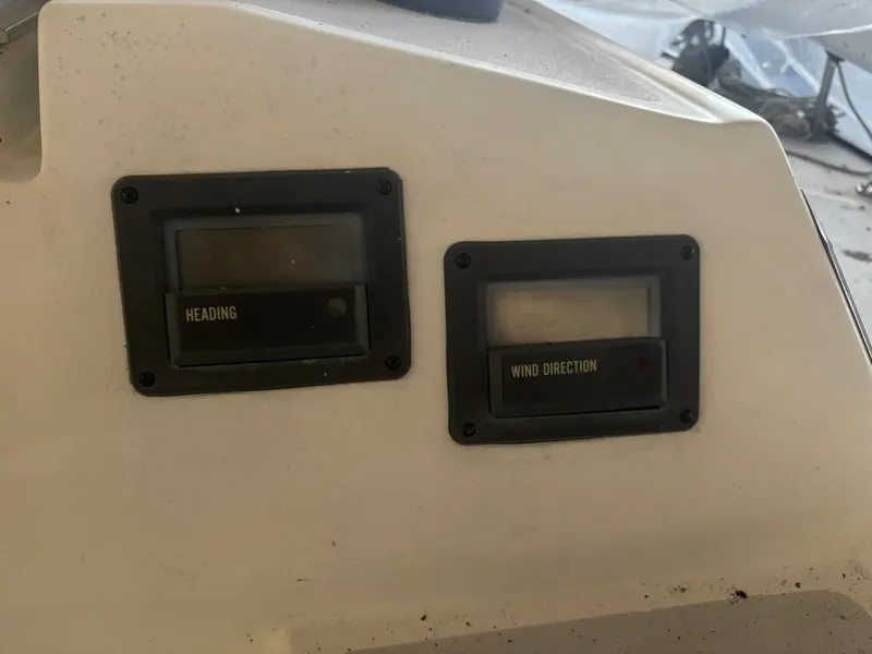 Slide: The Image of 1987 Holby Tripp boat dashboard with heading and wind direction gauges. - 27