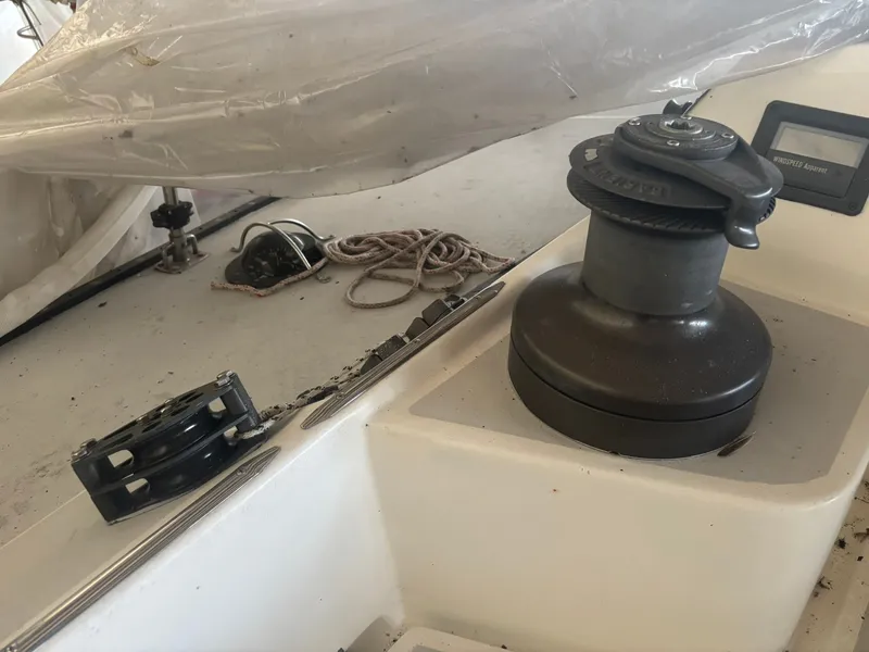 Slide: The Image of Deck equipment on a 1987 Holby Tripp sailboat, featuring winch and ropes. - 33