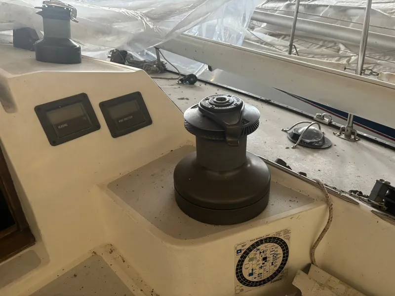 Slide: The Image of 1987 Holby Tripp sailboat cockpit with winch and navigation instruments. - 35