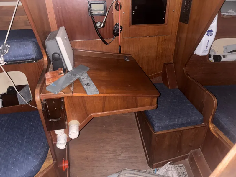 Slide: The Image of Interior of a 1987 Holby Tripp boat with wooden furnishings and navigation equipment. - 44