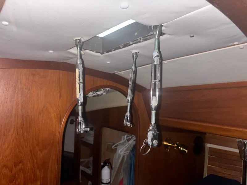 Slide: The Image of Interior of 1987 Holby Tripp sailboat showing rigging hardware and wooden paneling. - 46