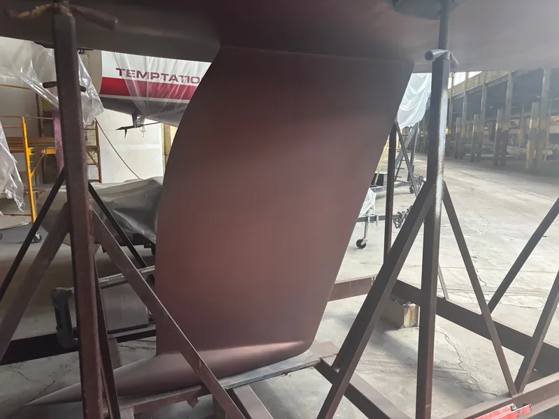 Slide: The Image of 1987 Holby Tripp boat keel in a workshop setting. - 9