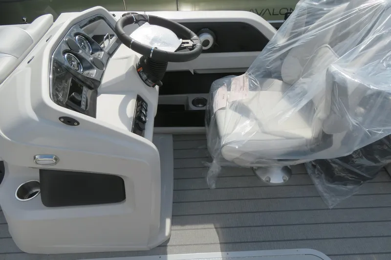 Slide: The Image of 2026 Avalon 2385 LSZ Quad Lounger helm with covered captain's chair and modern controls. - 20