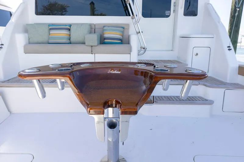 Slide: The Image of 2008 Ocean Yachts 54 Super Sport cockpit with polished wood table and cushioned seating. - 11