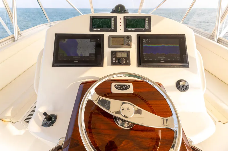 Slide: The Image of Helm of 2008 Ocean Yachts 54 Super Sport with navigation displays and wooden steering wheel. - 15