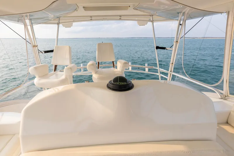 Slide: The Image of 2008 Ocean Yachts 54 Super Sport helm with ocean view, featuring white seating and navigation equipment. - 16